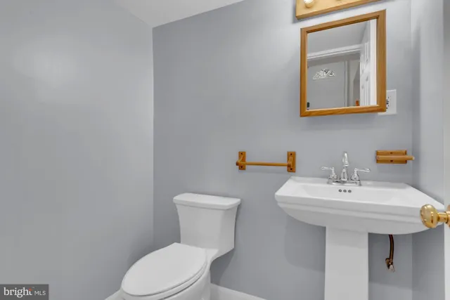 a bathroom with a sink a mirror and a toilet