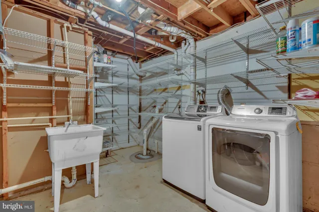 a room with a washing machine and a fireplace