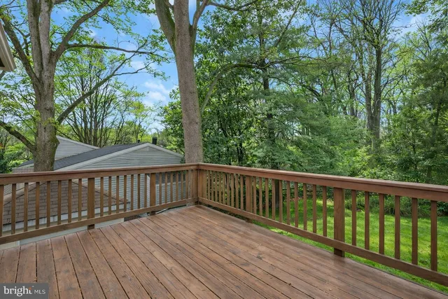a view of balcony with wooden floor and fence