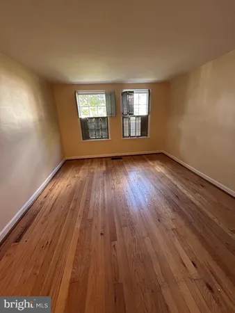 a view of wooden floor and windows in a room