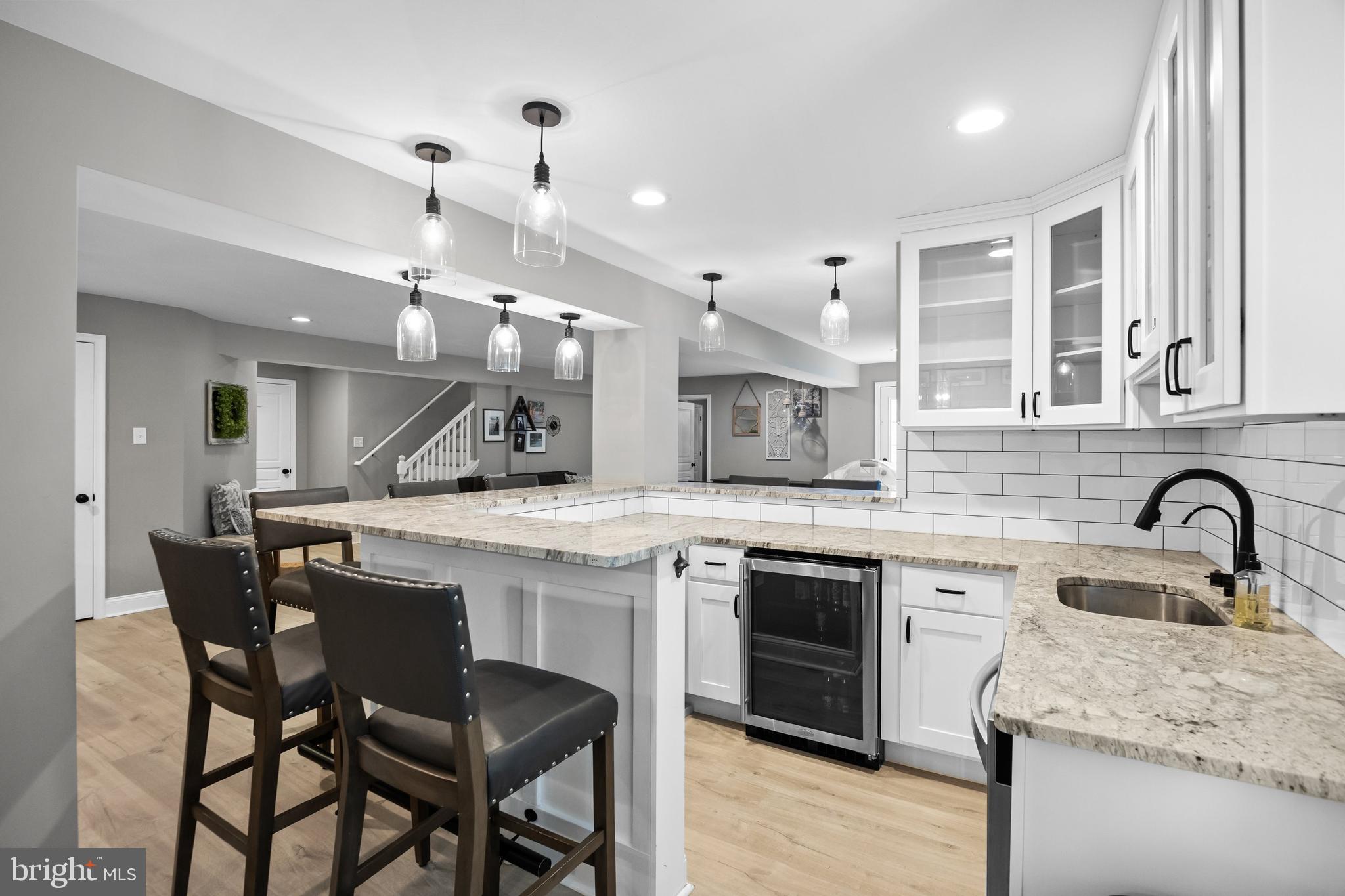 206 Sullivan Drive Mickleton, NJ 08056 - Photo 34 of 59 a kitchen with cabinets a sink dishwasher a stove and a refrigerator with wooden floor