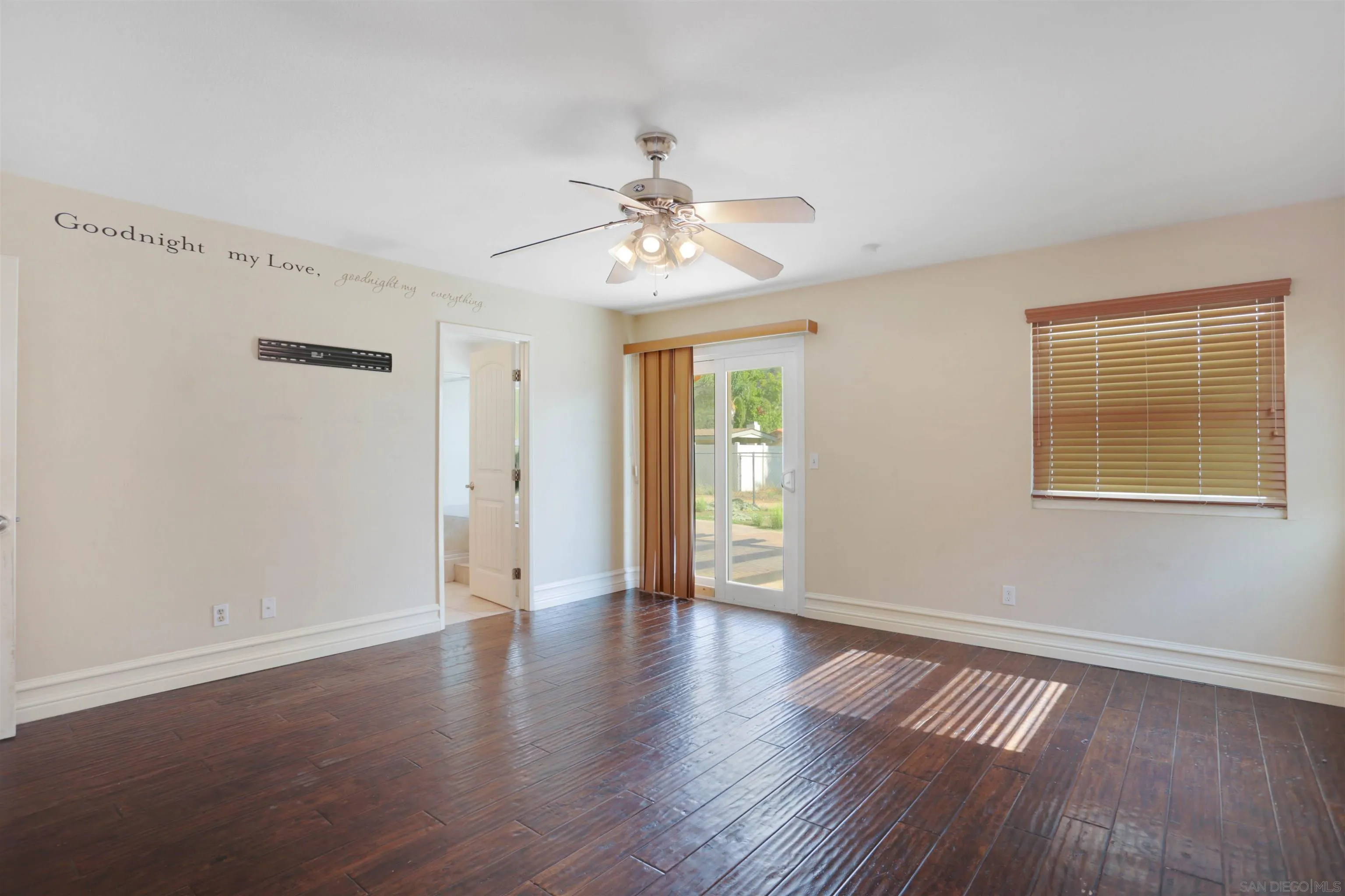 23641 Springwood Drive Ramona, CA 92065 - Photo 15 of 34 a view of an empty room with a window and wooden floor