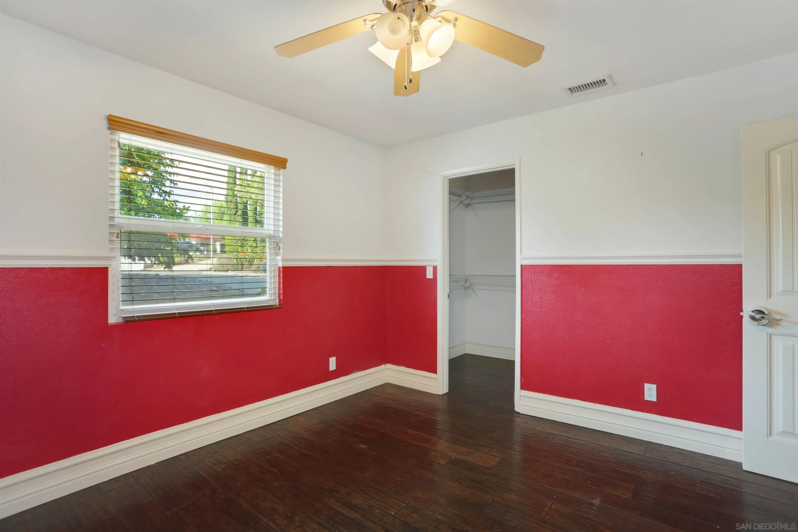 23641 Springwood Drive Ramona, CA 92065 - Photo 18 of 34 a view of an empty room with wooden floor and a window
