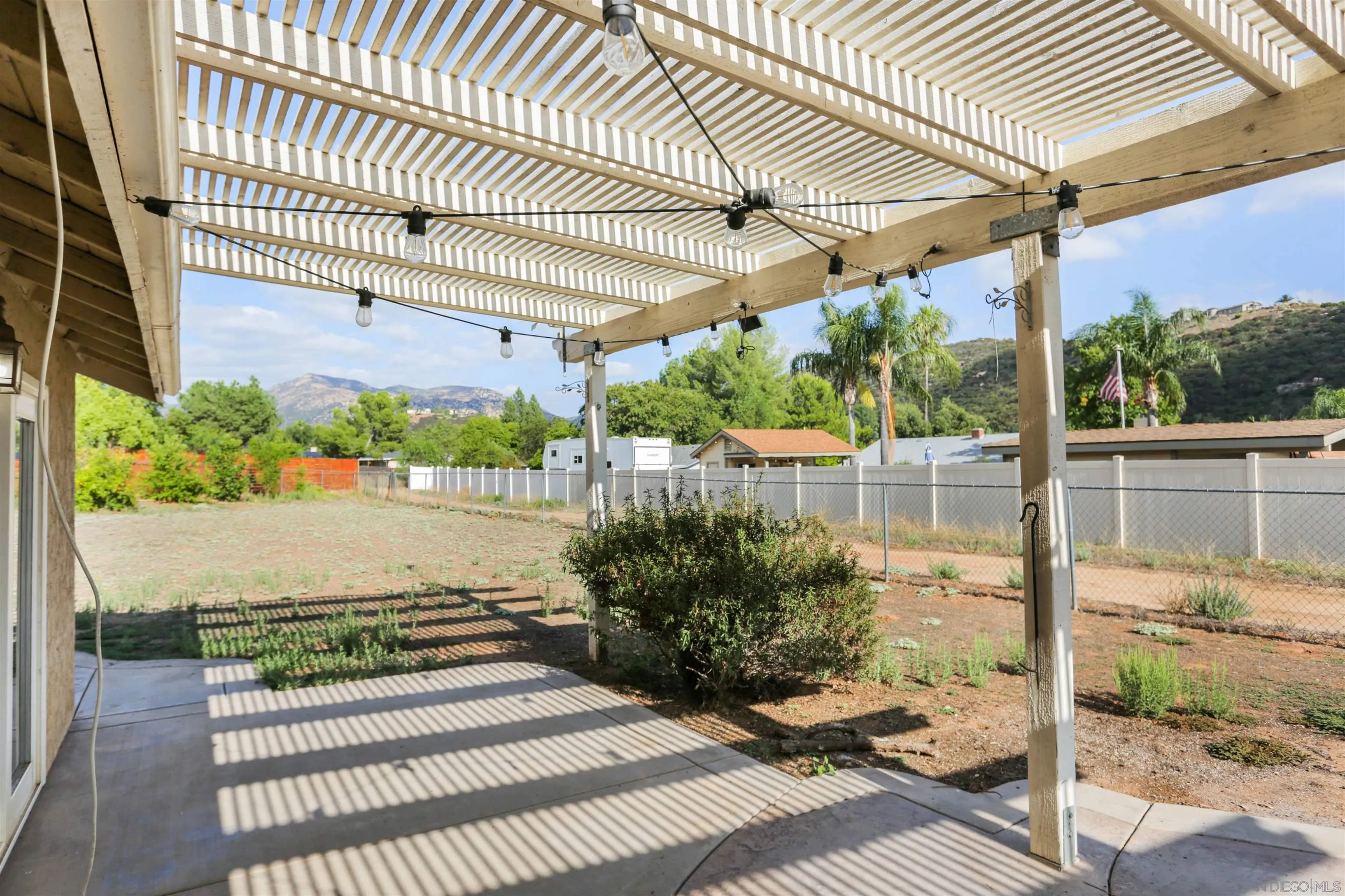 23641 Springwood Drive Ramona, CA 92065 - Photo 25 of 34 a view of a patio with table and chairs and potted plants