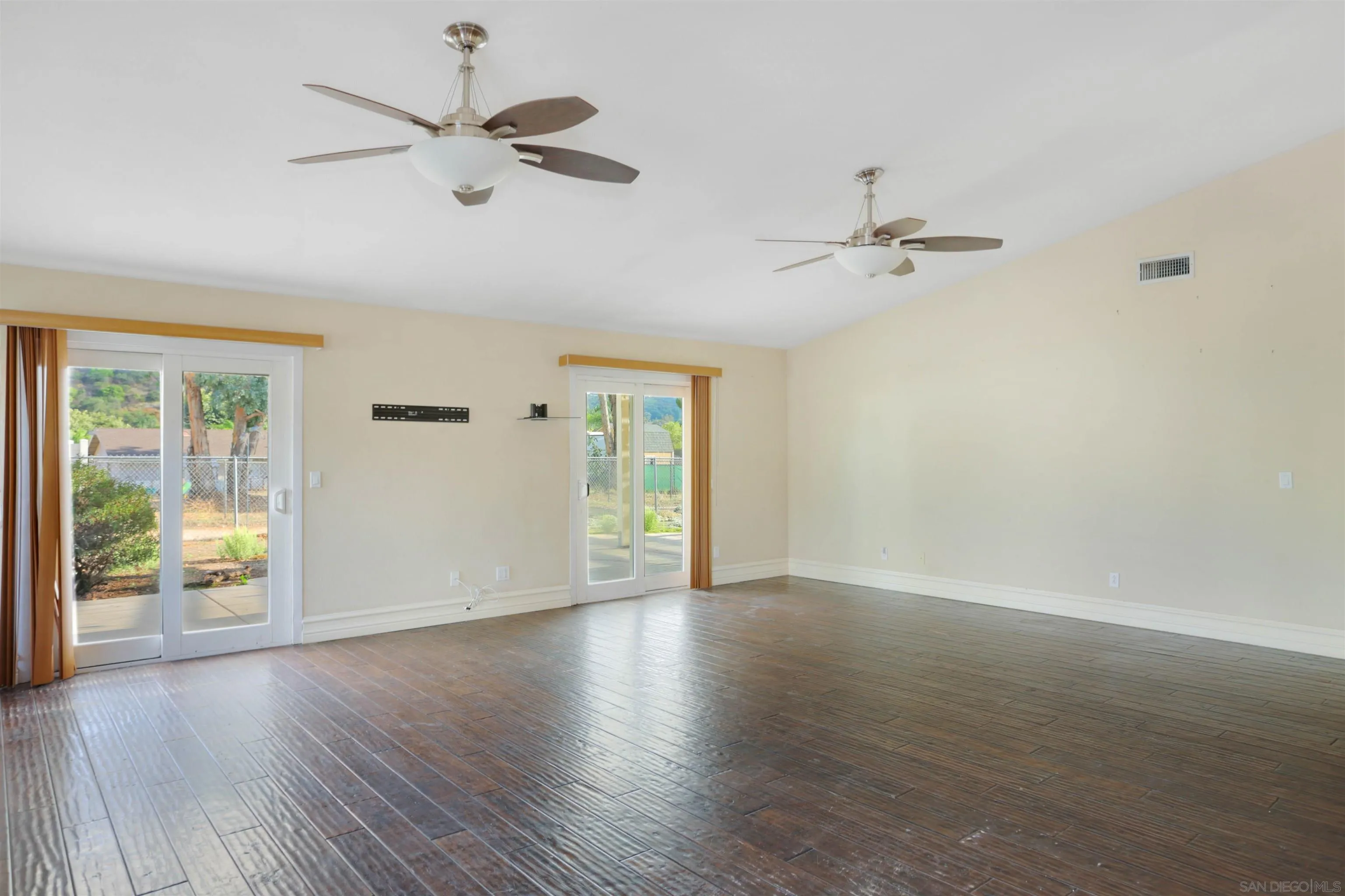 23641 Springwood Drive Ramona, CA 92065 - Photo 3 of 34 a view of an empty room with a window and wooden floor