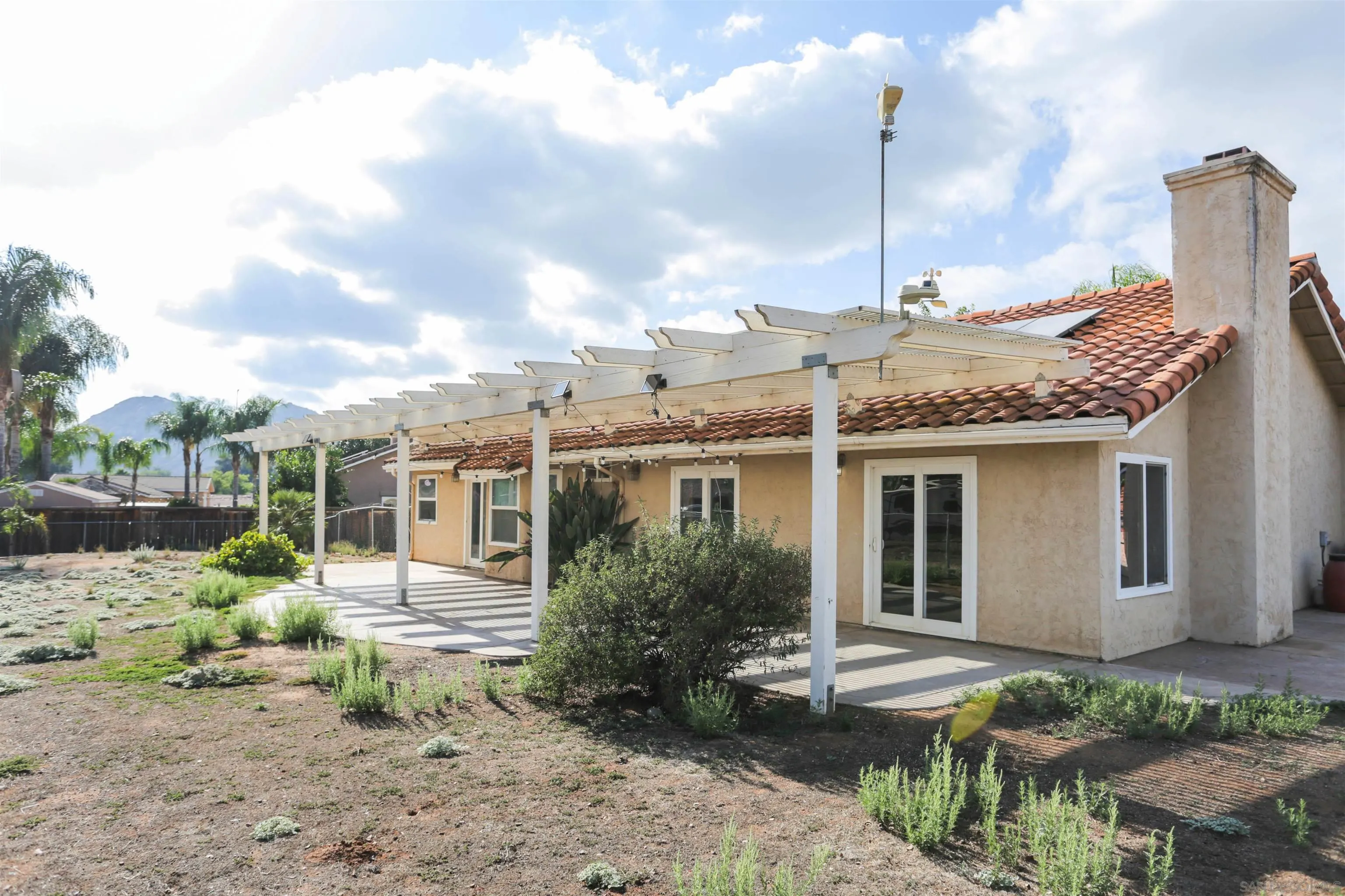 23641 Springwood Drive Ramona, CA 92065 - Photo 32 of 34 a view of a house with a yard and plants
