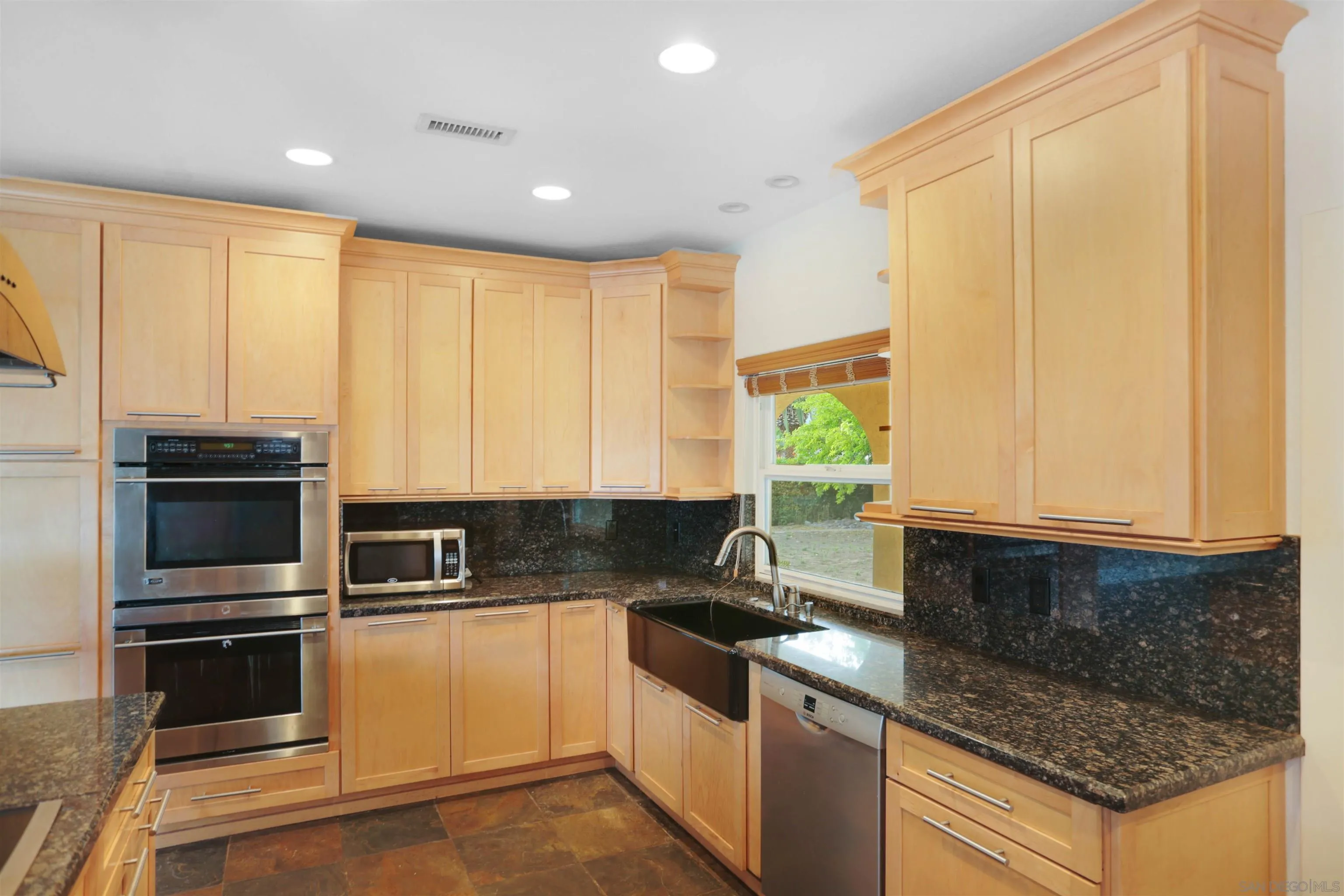 23641 Springwood Drive Ramona, CA 92065 - Photo 6 of 34 a kitchen with stainless steel appliances granite countertop a stove a sink and a microwave