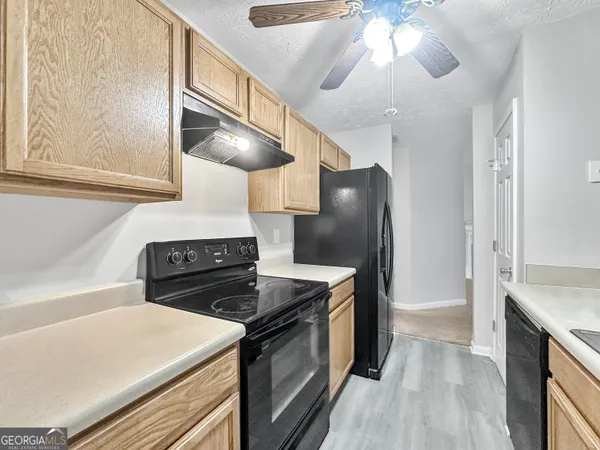 a kitchen with a stove and a refrigerator
