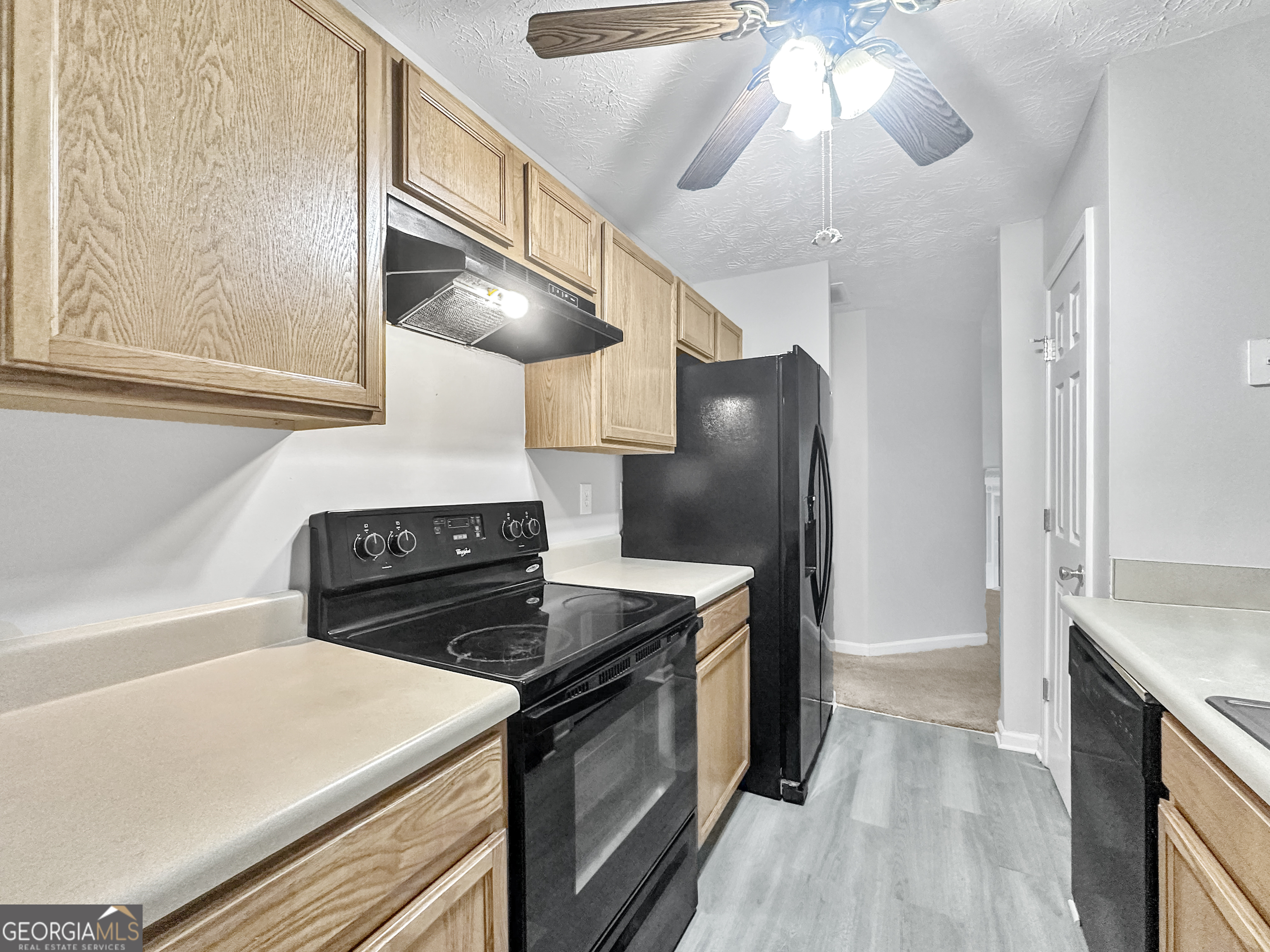 400 Crestfield Circle Covington, GA 30016 - Photo 4 of 16 a kitchen with a stove and a refrigerator