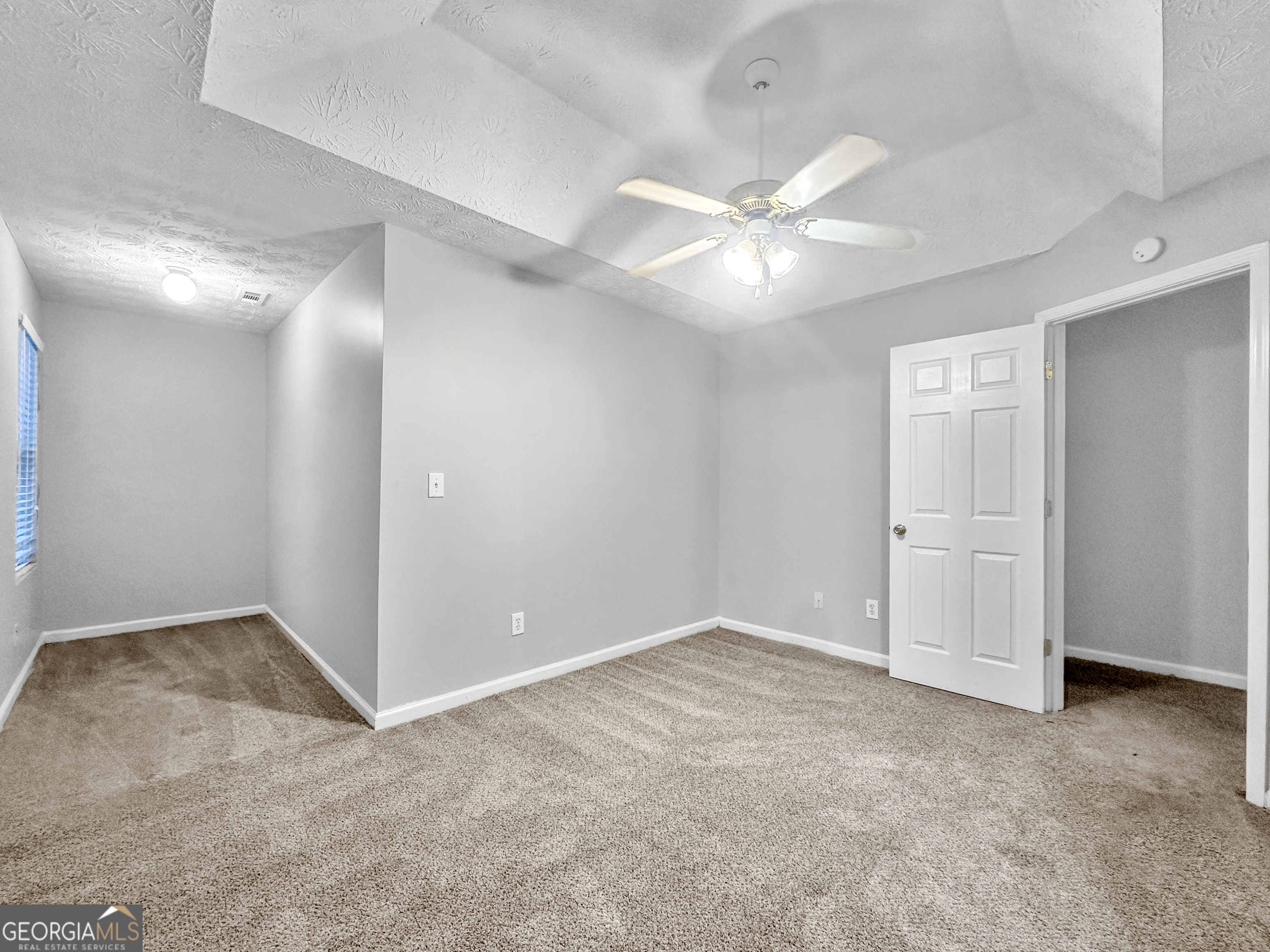 400 Crestfield Circle Covington, GA 30016 - Photo 10 of 16 an empty room with closet and fan