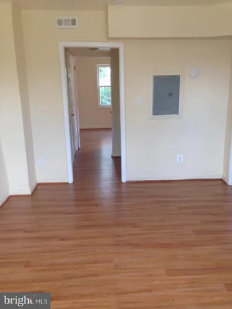 a view of a room with wooden floor