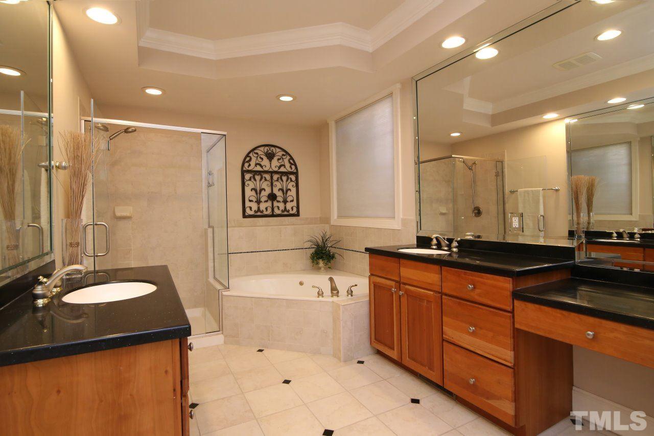 1841 Torrington Street Raleigh, NC 27615 - Photo 13 of 25 a bathroom with a granite countertop sink a toilet a mirror and shower