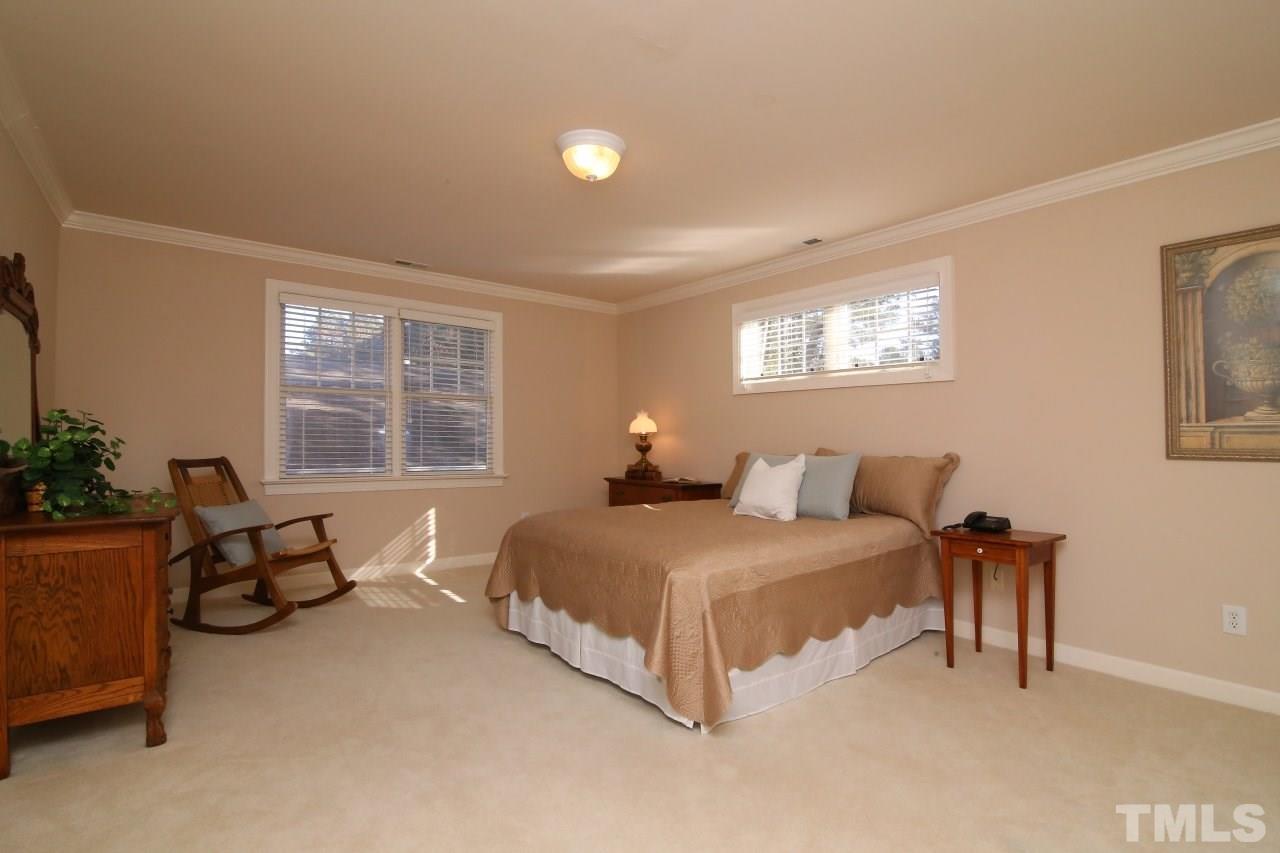 1841 Torrington Street Raleigh, NC 27615 - Photo 18 of 25 a bedroom with a bed and a couch