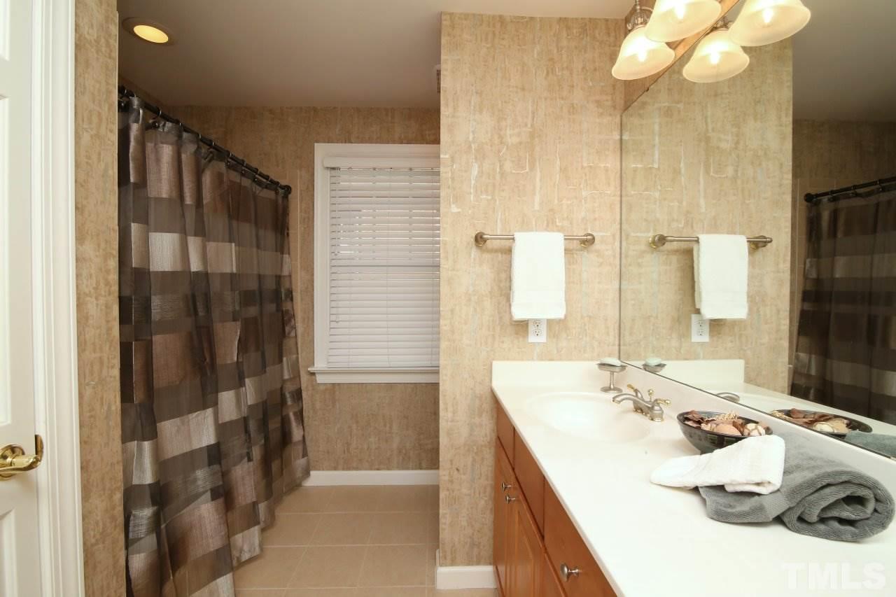1841 Torrington Street Raleigh, NC 27615 - Photo 19 of 25 a bathroom with a sink and a mirror