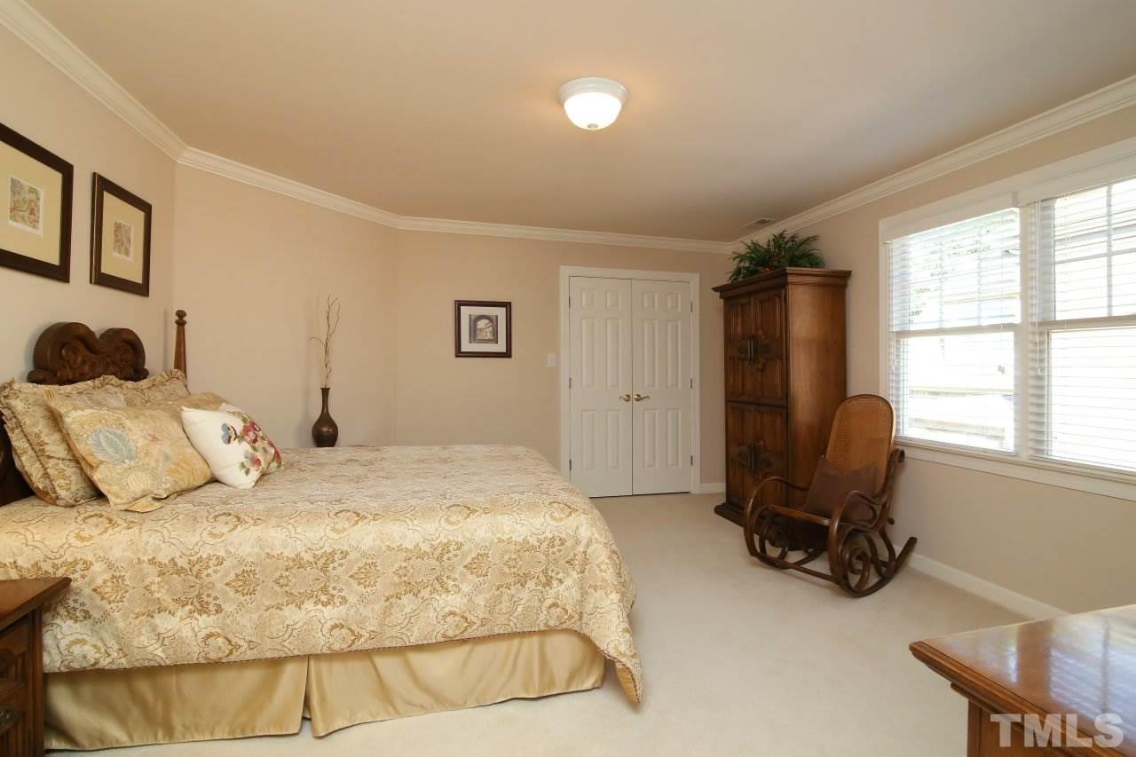 1841 Torrington Street Raleigh, NC 27615 - Photo 20 of 25 a bedroom with a bed and a large window