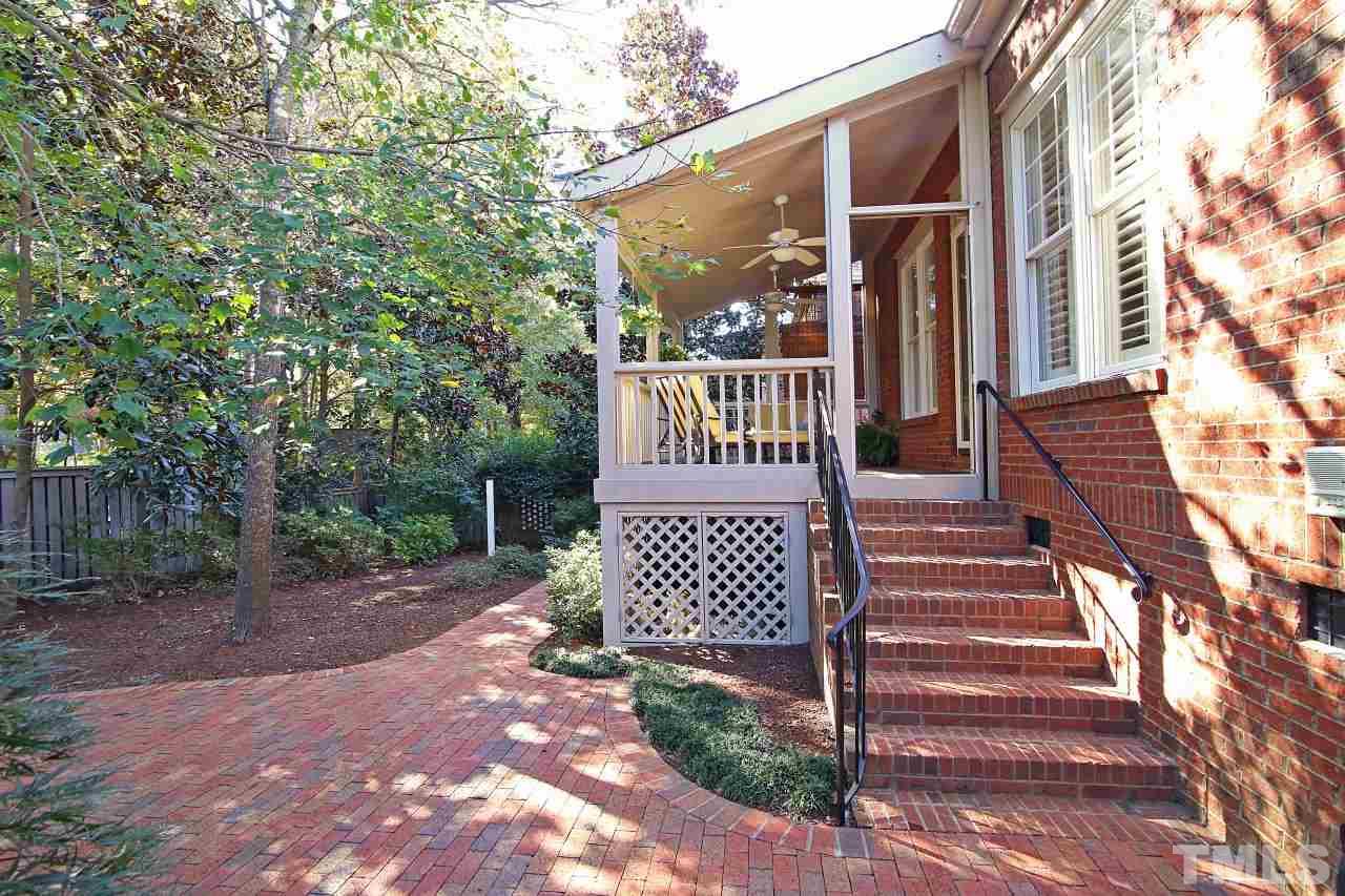 1841 Torrington Street Raleigh, NC 27615 - Photo 23 of 25 a view of a brick wall with windows and wooden fence