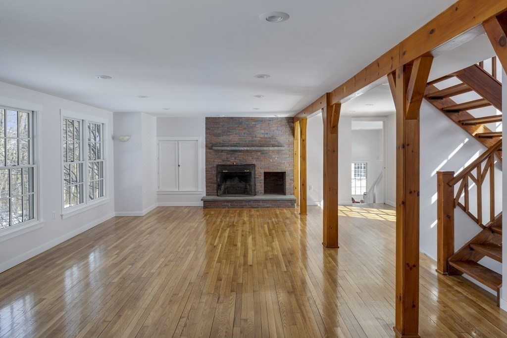 18 South Shaker Road Harvard, MA 01451 - Photo 17 of 36 a view of empty room with wooden floor and fireplace