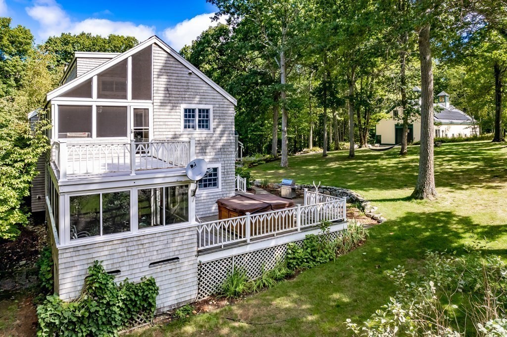 18 South Shaker Road Harvard, MA 01451 - Photo 25 of 36 a front view of a house with a yard table and chairs