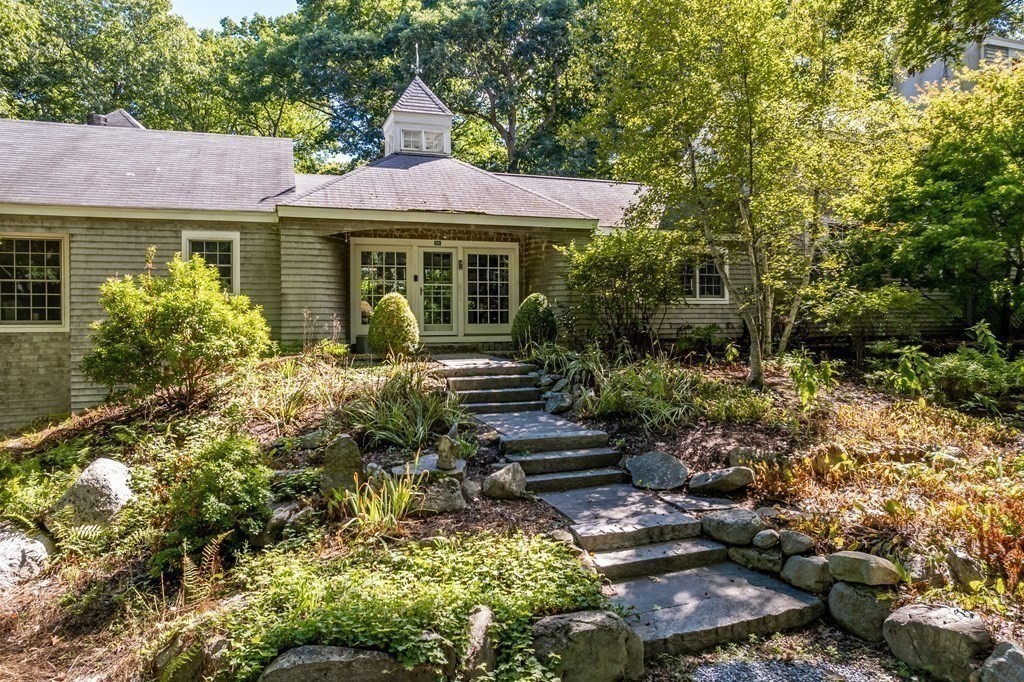 18 South Shaker Road Harvard, MA 01451 - Photo 32 of 36 a front view of a house with a yard and potted plants