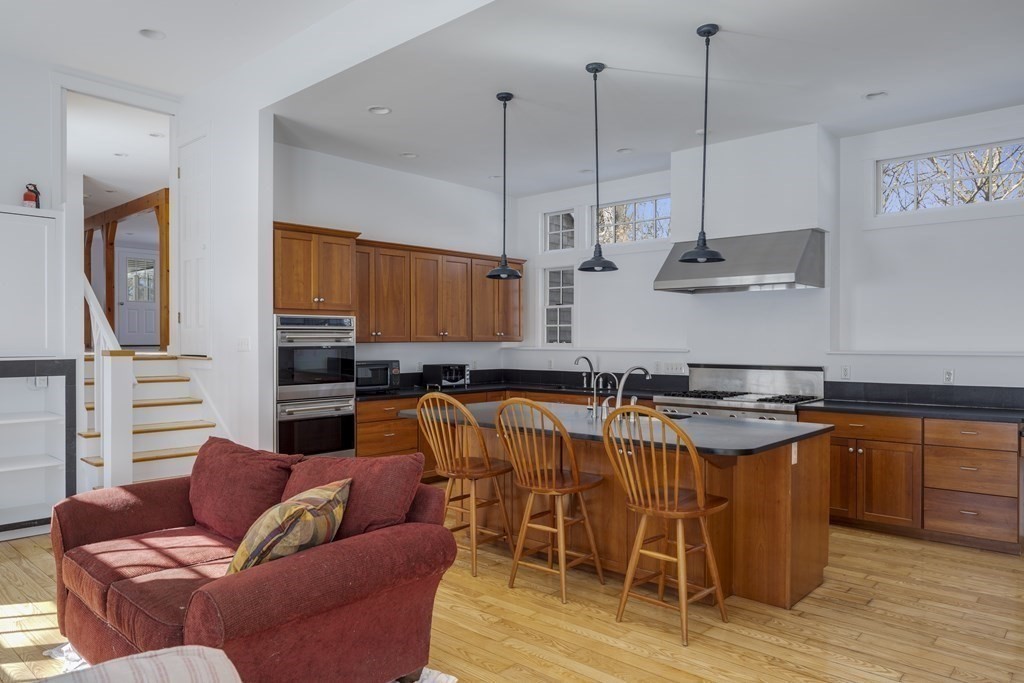 18 South Shaker Road Harvard, MA 01451 - Photo 8 of 36 a kitchen with stainless steel appliances granite countertop a sink a stove and a wooden floors