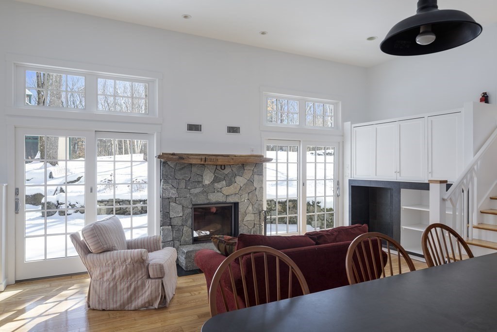 18 South Shaker Road Harvard, MA 01451 - Photo 9 of 36 a living room with furniture a fireplace and a large window
