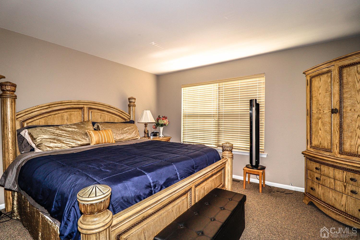 8 Prestwick Way Edison, NJ 08820 - Photo 16 of 27 a bed sitting in a bedroom next to a window