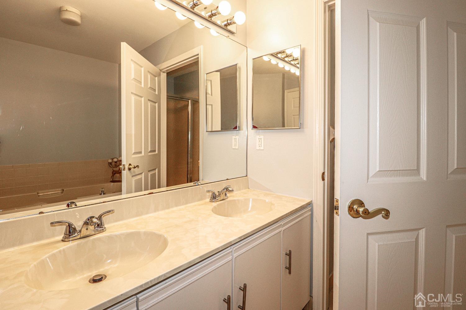 8 Prestwick Way Edison, NJ 08820 - Photo 18 of 27 a bathroom with a sink and mirror