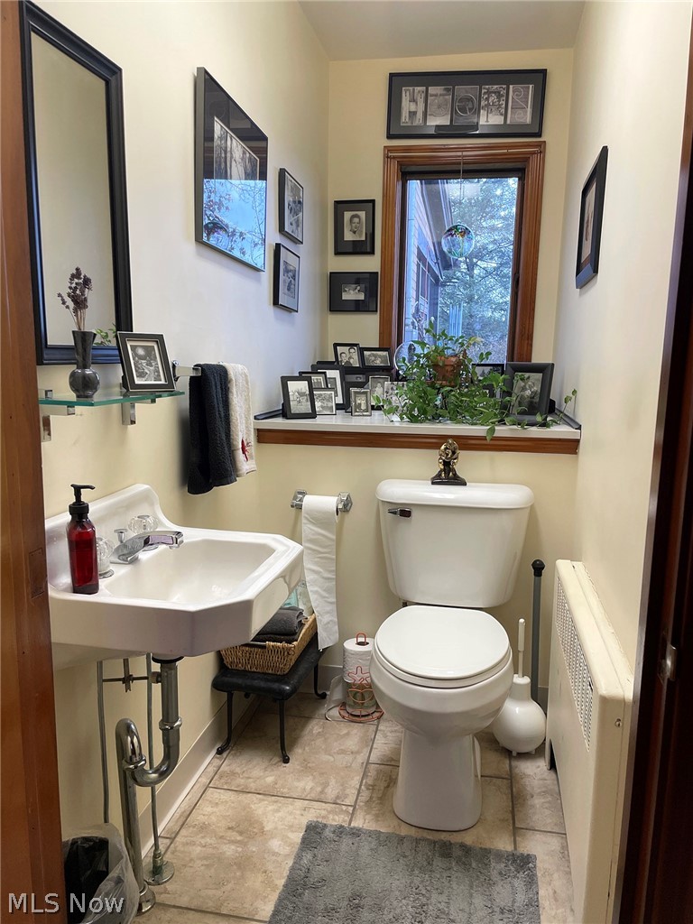 526 Ridgeleigh Street Minerva, OH 44657 - Photo 22 of 28 Bathroom featuring tile floors, radiator heating unit, and toilet