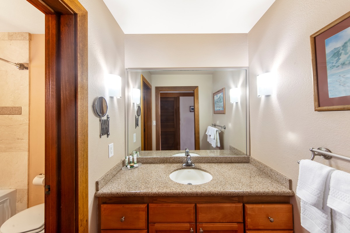 2253 Poipu Road, Unit 311 Koloa, HI 96756 - Photo 16 of 19 a en suite bathroom with a granite countertop sink and a mirror