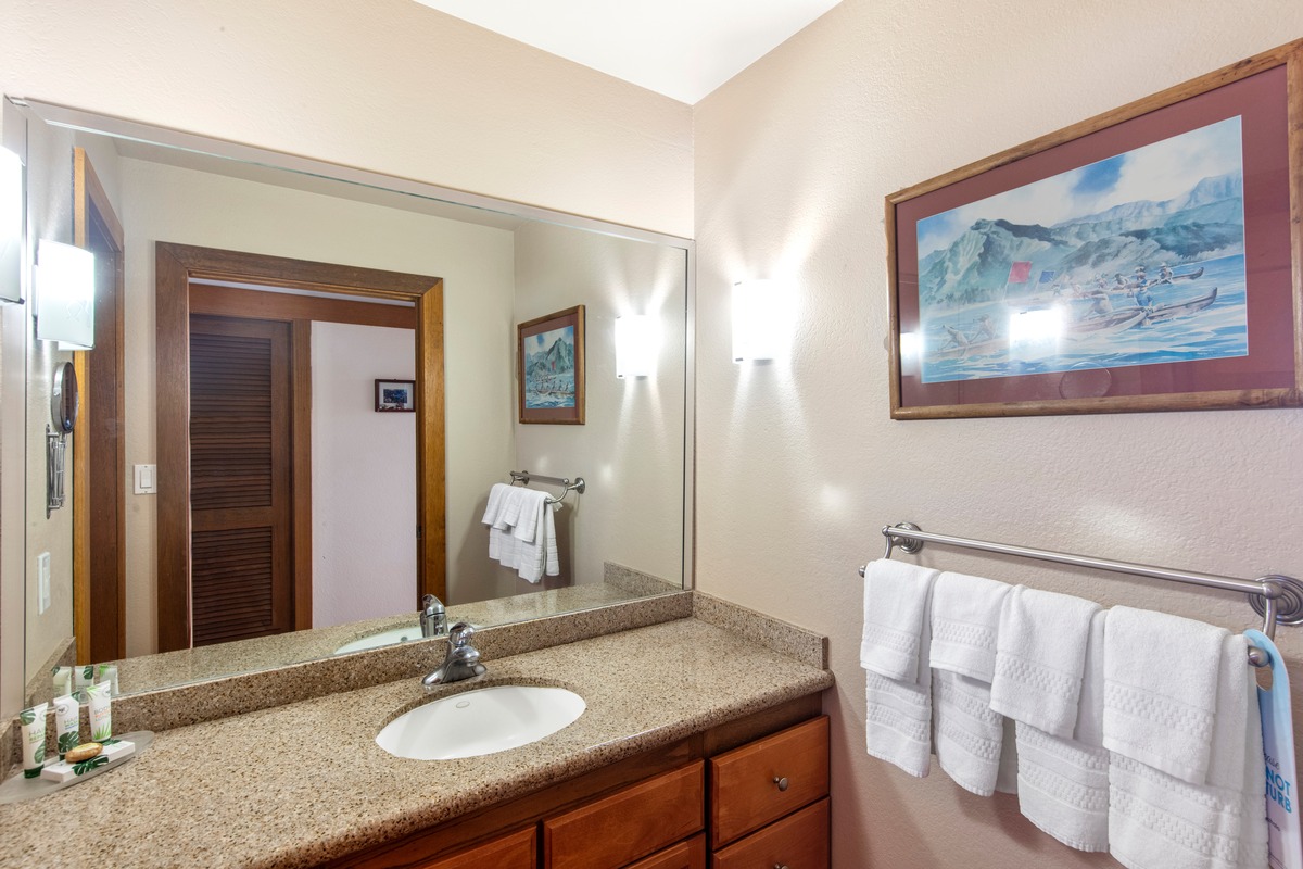 2253 Poipu Road, Unit 311 Koloa, HI 96756 - Photo 17 of 19 a bathroom with a granite countertop sink a mirror and a