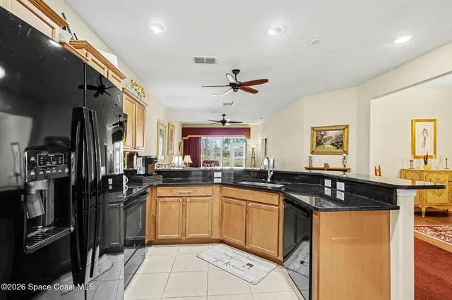 a living room with furniture and a view of kitchen