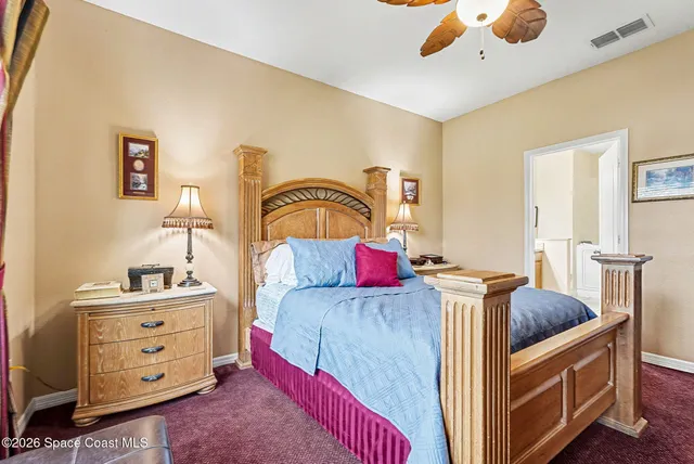 a spacious bedroom with a bed and a cabinets