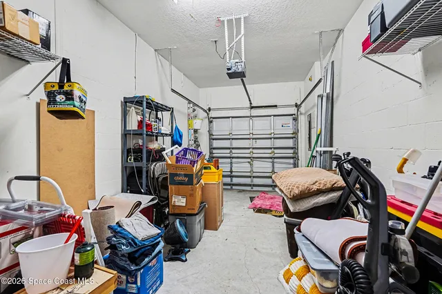 a view of a room with a window and furniture