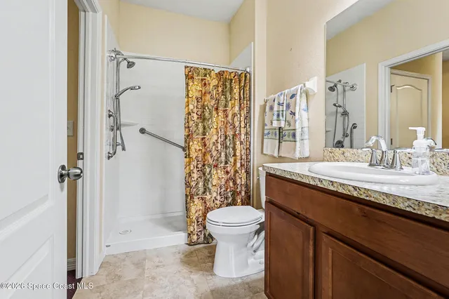 a kitchen with kitchen island a counter top space a sink stainless steel appliances and cabinets