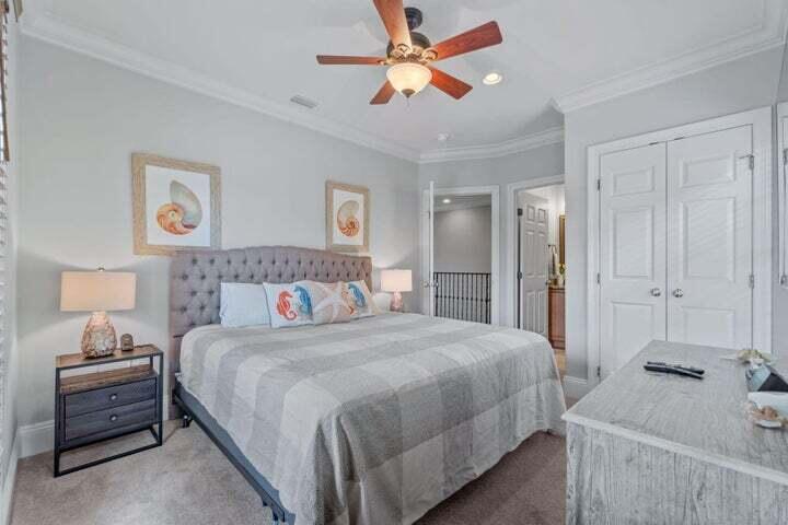 1900 Baytowne Loop Miramar Beach, FL 32550 - Photo 24 of 44 a bedroom with a bed and a chandelier