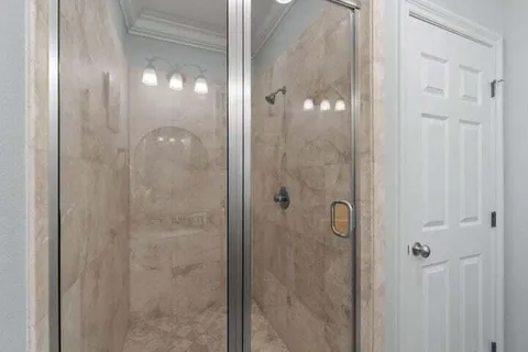 a bathroom with a glass shower door