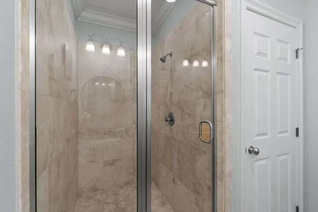a bathroom with a glass shower door