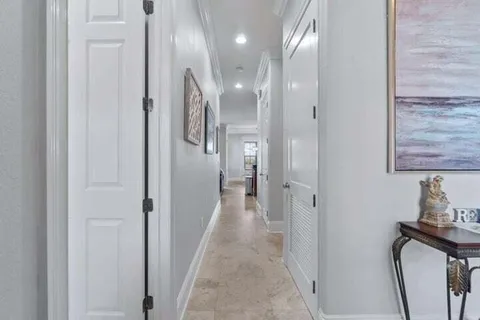 a view of a hallway with wooden floor