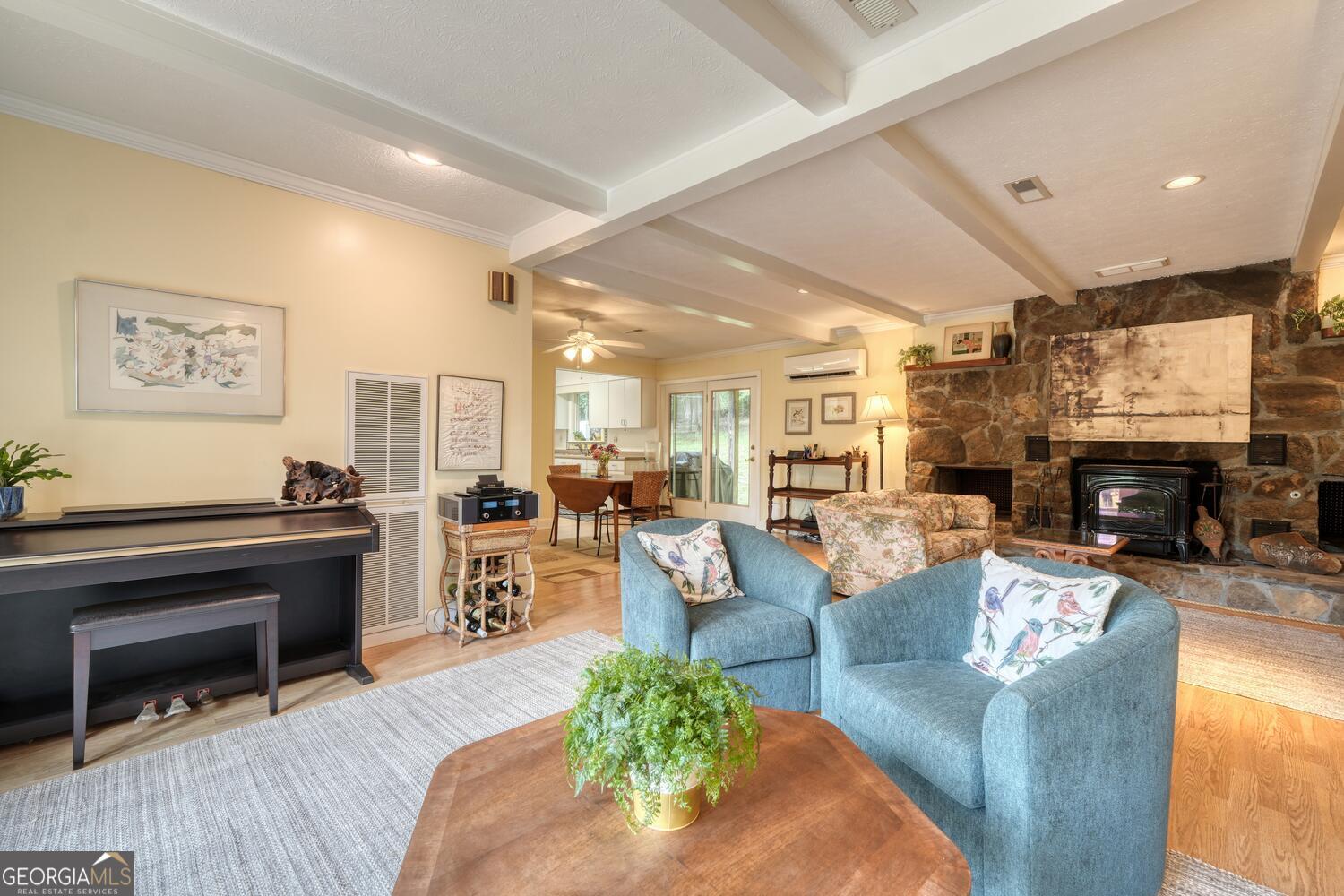 3291 Moccasin Creek Road Murphy, NC 28906 - Photo 19 of 78 a living room with furniture a fireplace and a dining table with wooden floor