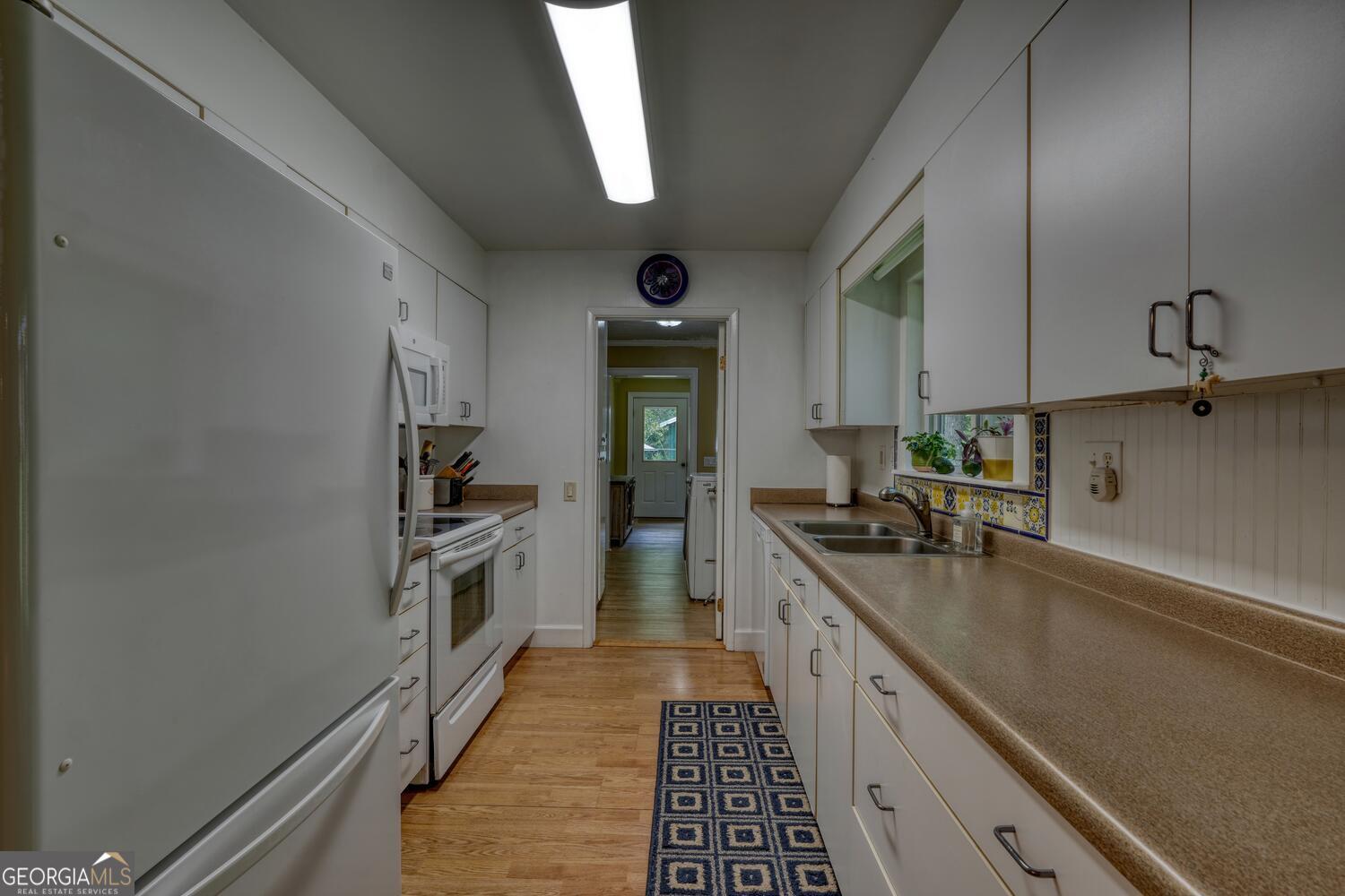 3291 Moccasin Creek Road Murphy, NC 28906 - Photo 25 of 78 a kitchen with a sink a stove and cabinets