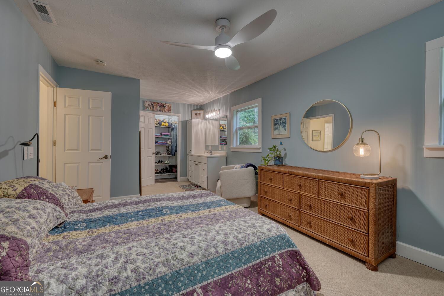 3291 Moccasin Creek Road Murphy, NC 28906 - Photo 31 of 78 a bed room with a bed and a mirror on a dresser