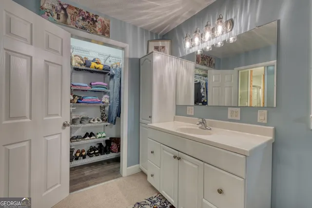 a bathroom with a toilet a sink and a mirror