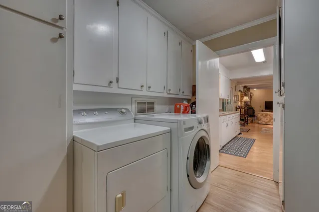 a front view of a house with a yard and green space