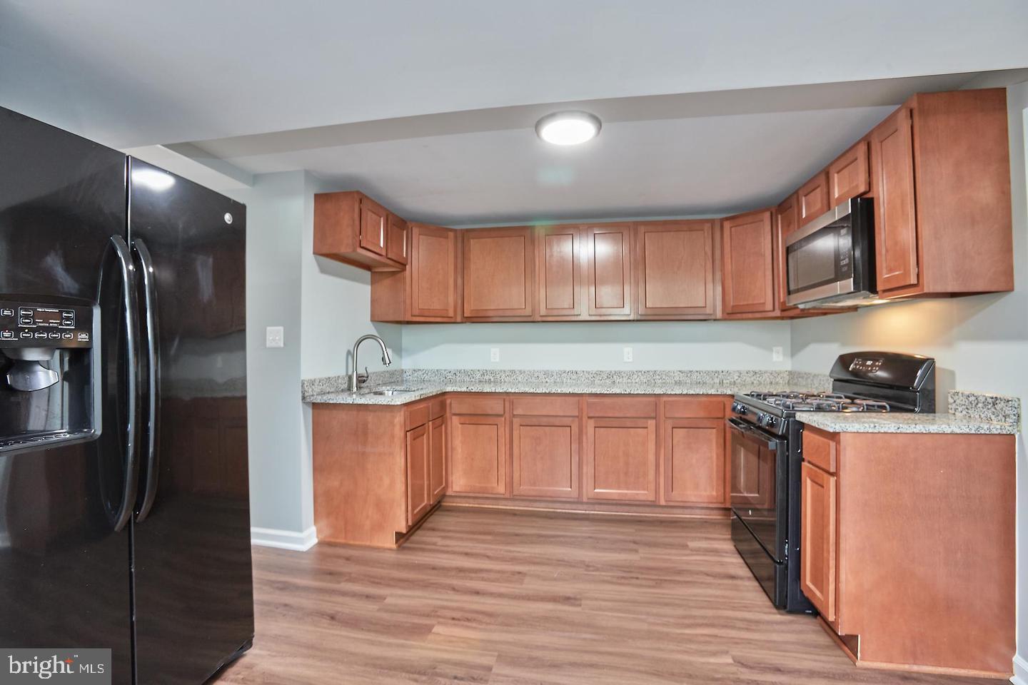 1007 Venice Drive Silver Spring, MD 20904 - Photo 28 of 39 a kitchen with stainless steel appliances granite countertop a refrigerator and a stove top oven