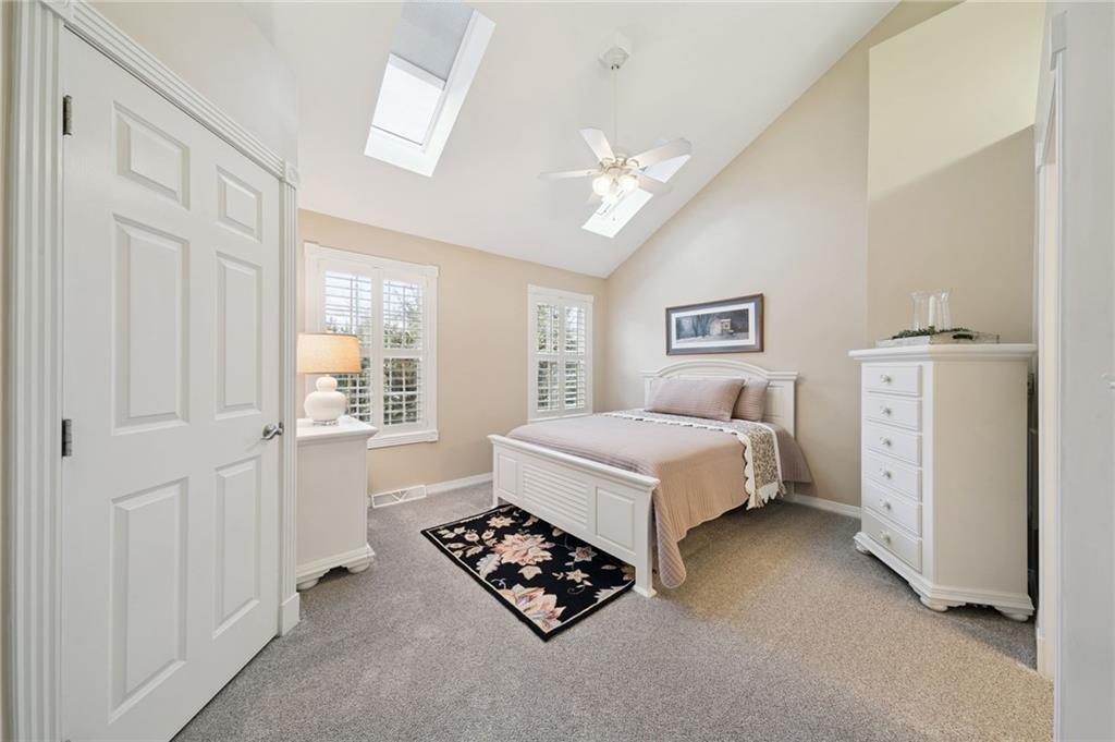 404 Beech Street Gibsonia, PA 15044 - Photo 14 of 32 a spacious bedroom with a bed and a chandelier