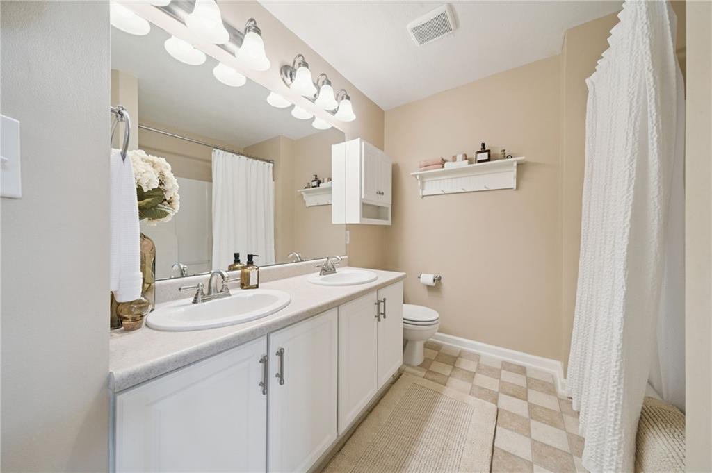 404 Beech Street Gibsonia, PA 15044 - Photo 21 of 32 a bathroom with a sink a vanity and a mirror