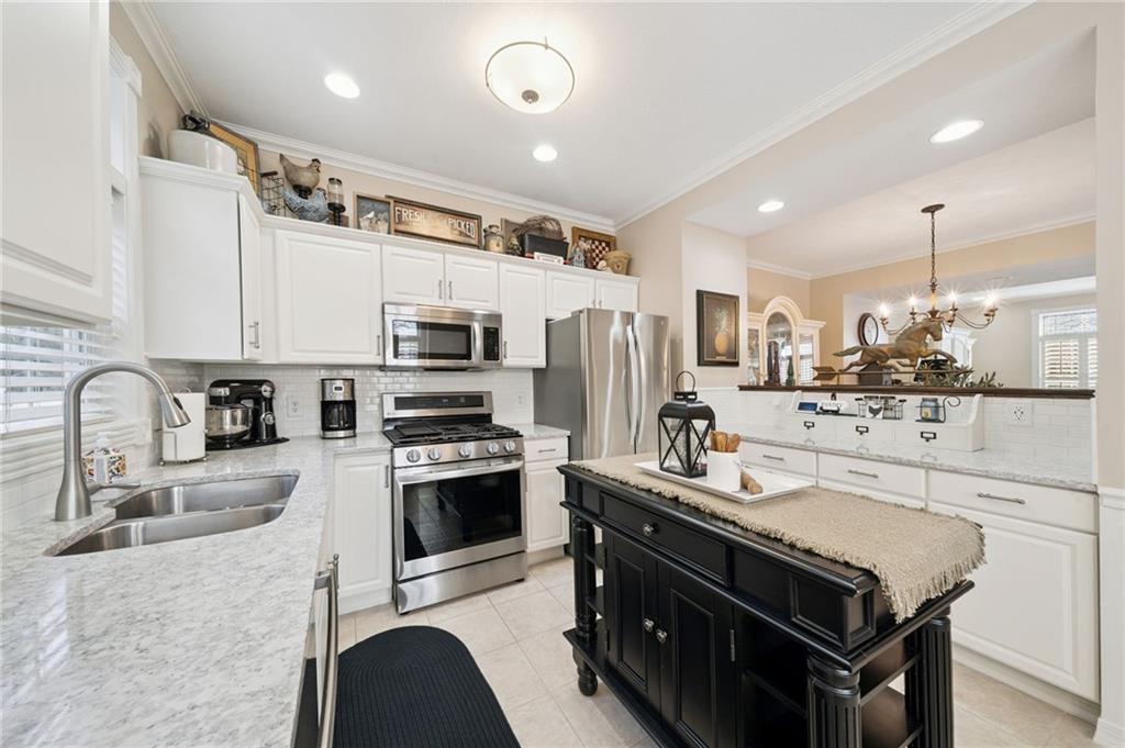 404 Beech Street Gibsonia, PA 15044 - Photo 8 of 32 a kitchen with stainless steel appliances granite countertop a sink stove refrigerator and cabinets