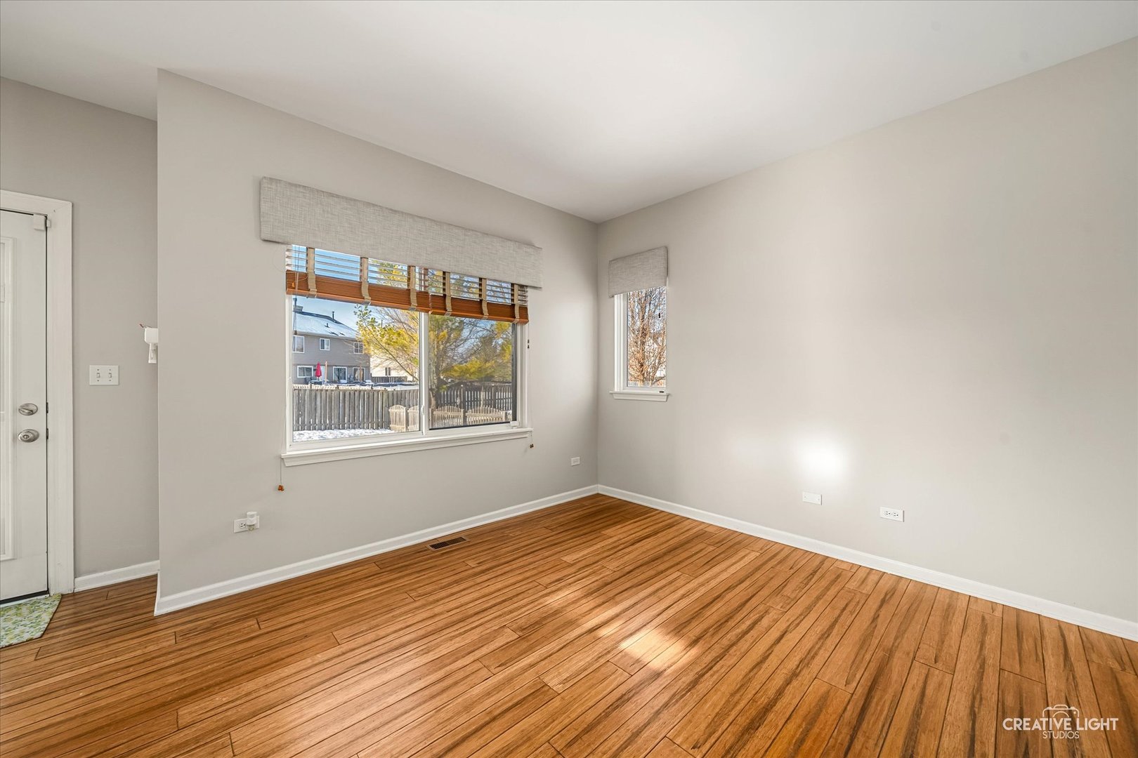 2455 Montclair Lane Montgomery, IL 60538 - Photo 6 of 22 a view of an empty room with wooden floor and a window