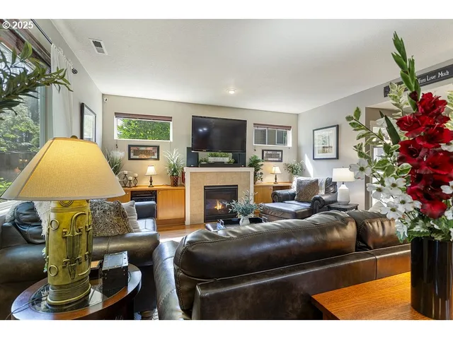 a living room with furniture a flat screen tv and a fireplace