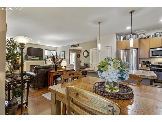 a living room with furniture a chandelier and a dining table